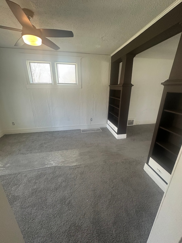 spare room with visible vents, baseboards, ceiling fan, a textured ceiling, and carpet