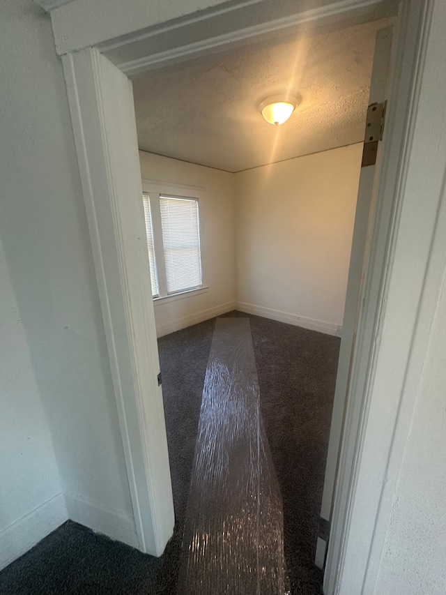 carpeted empty room with baseboards
