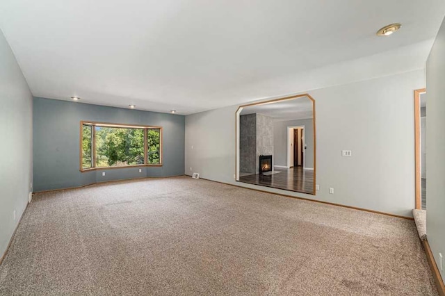 410 Orchard Ct, Saint Louis, MI 48880 - spare room featuring carpet floors, baseboards, and a tile fireplace