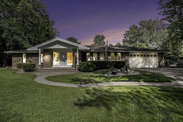 410 Orchard Ct, Saint Louis, MI 48880 - ranch-style home featuring a yard, brick siding, an attached garage, and concrete driveway
