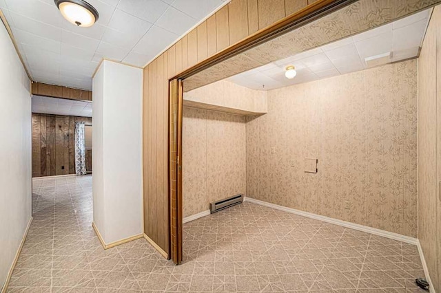 410 Orchard Ct, Saint Louis, MI 48880 - corridor with a baseboard radiator, light floors, and wooden walls