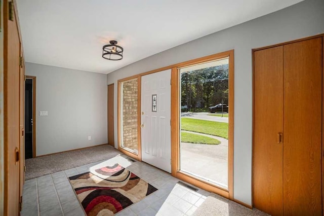 410 Orchard Ct, Saint Louis, MI 48880 - foyer entrance featuring light tile patterned floors and light colored carpet