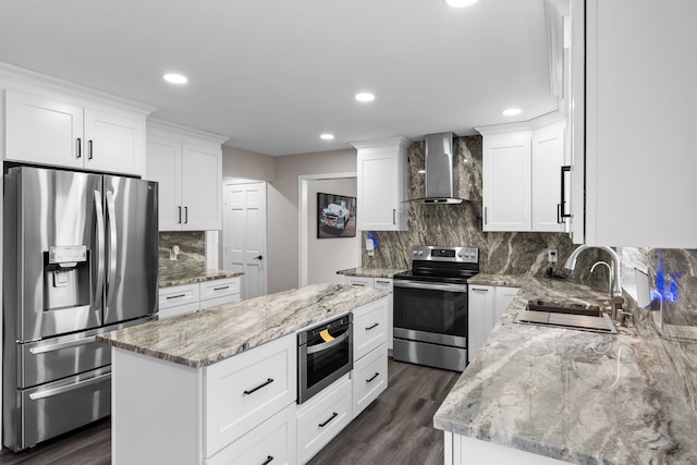 5615 Woodmire Dr, Macomb, MI 48316 - kitchen featuring decorative backsplash, a center island, a sink, stainless steel appliances, and wall chimney exhaust hood