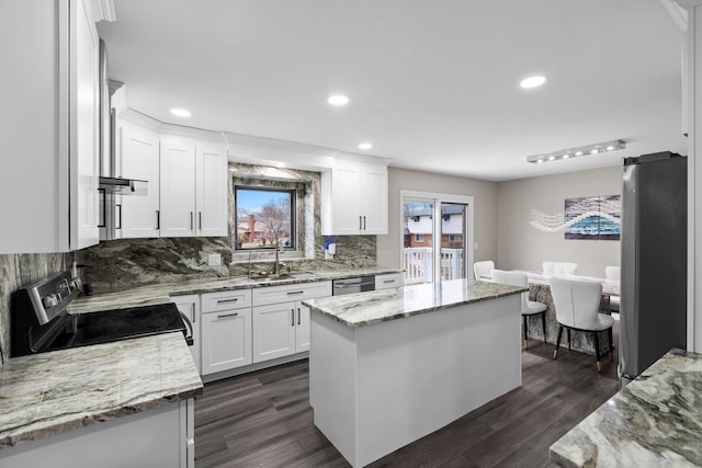 5615 Woodmire Dr, Macomb, MI 48316 - kitchen with stainless steel appliances, decorative backsplash, a sink, and white cabinetry