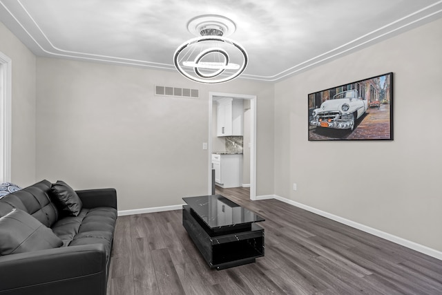 5615 Woodmire Dr, Macomb, MI 48316 - living area with an inviting chandelier, dark wood-style flooring, baseboards, and visible vents