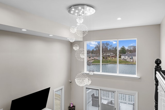 5615 Woodmire Dr, Macomb, MI 48316 - details featuring a water view, recessed lighting, and a chandelier