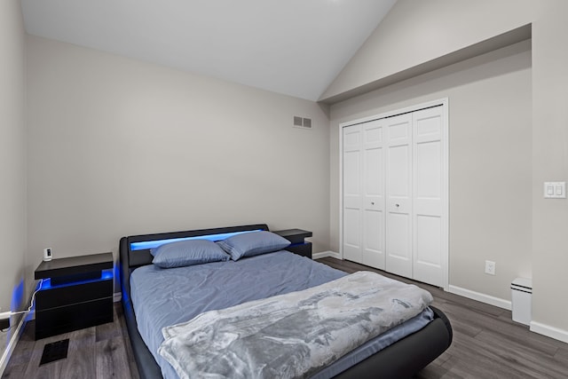 5615 Woodmire Dr, Macomb, MI 48316 - bedroom with visible vents, wood finished floors, baseboards, high vaulted ceiling, and a closet