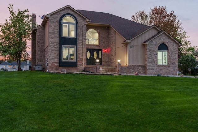 5615 Woodmire Dr, Macomb, MI 48316 - traditional-style home with a chimney, a front lawn, and brick siding