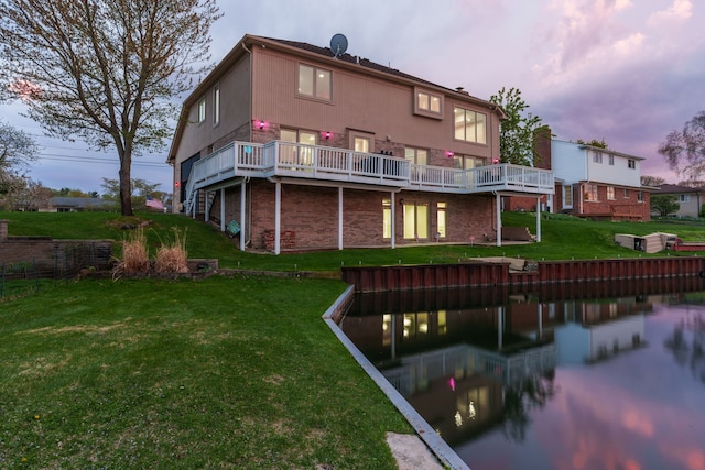 5615 Woodmire Dr, Macomb, MI 48316 - rear view of property featuring a lawn, a deck with water view, and brick siding