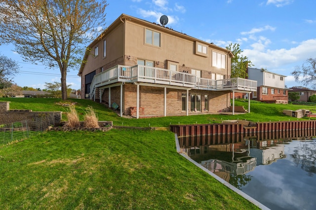 5615 Woodmire Dr, Macomb, MI 48316 - back of property with a deck with water view, a lawn, and brick siding