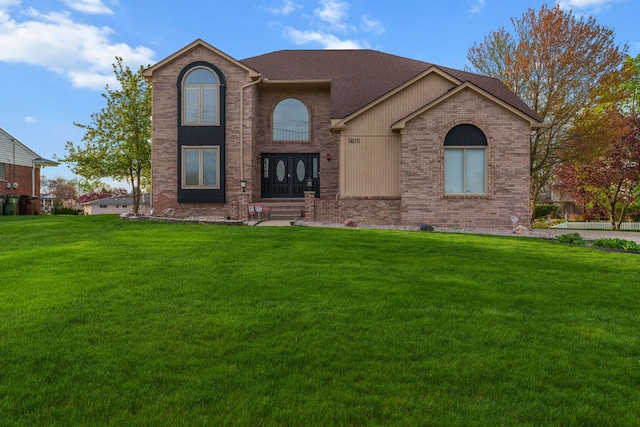5615 Woodmire Dr, Macomb, MI 48316 - traditional-style house with brick siding, a shingled roof, and a front yard