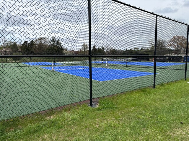 view of tennis court with fence