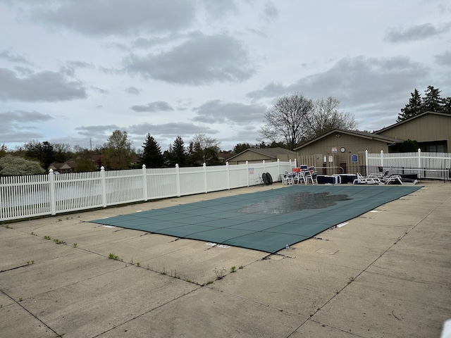 community pool featuring a patio area and fence