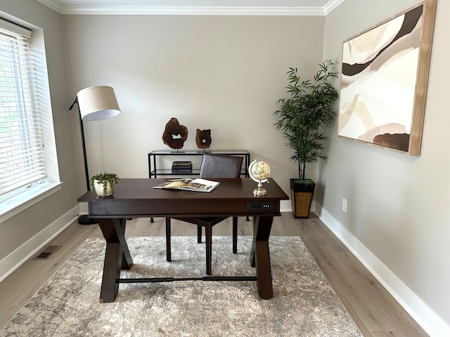 office featuring crown molding, wood finished floors, baseboards, and healthy amount of natural light