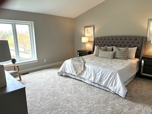 bedroom featuring vaulted ceiling, carpet, and baseboards
