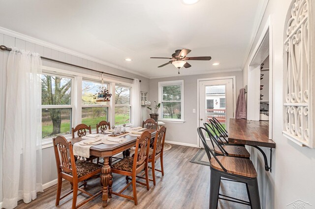 1349 Mckimmy Rd, Beaverton, MI 48612 - dining space with ceiling fan, wood finished floors, baseboards, ornamental molding, and recessed lighting