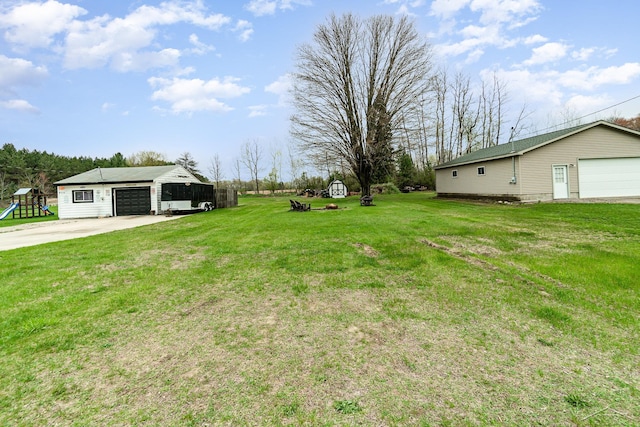 1349 Mckimmy Rd, Beaverton, MI 48612 - view of yard featuring an outdoor structure and a detached garage
