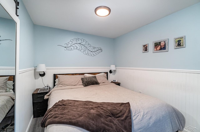 1349 Mckimmy Rd, Beaverton, MI 48612 - bedroom with wainscoting and wood finished floors