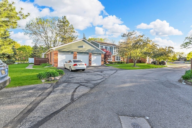 2917 Whittier Ct, Ann Arbor, MI 48104 - view of front of home featuring driveway, a front yard, brick siding, and an attached garage