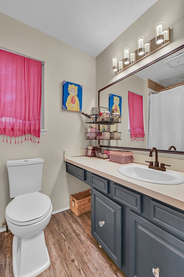 2917 Whittier Ct, Ann Arbor, MI 48104 - bathroom with wood finished floors, vanity, toilet, and baseboards