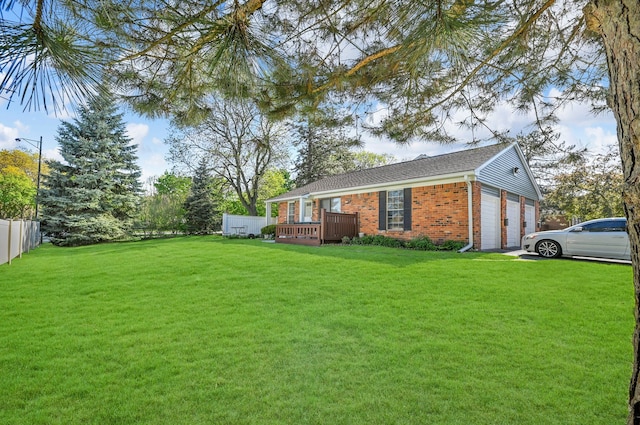 2917 Whittier Ct, Ann Arbor, MI 48104 - view of property exterior with brick siding, a wooden deck, an attached garage, and driveway