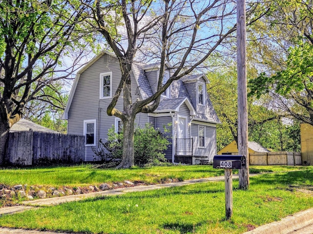 view of home's exterior featuring fence and a yard