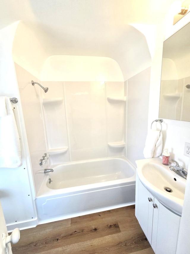 bathroom featuring vanity, bathtub / shower combination, and wood finished floors