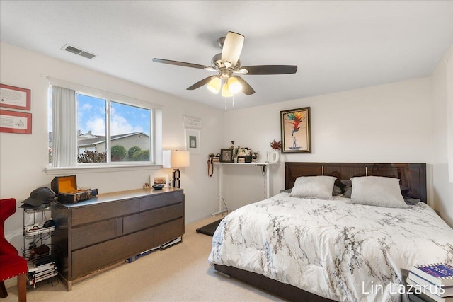 bedroom featuring light carpet, a ceiling fan, and visible vents
