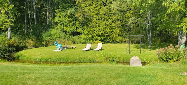 view of home's community featuring a lawn
