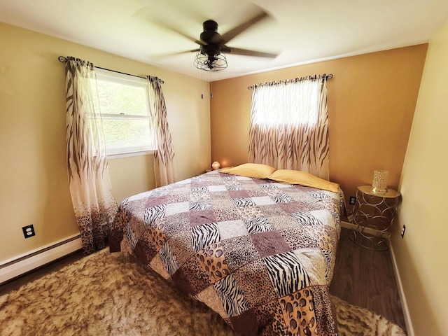 bedroom with baseboards, a baseboard radiator, ceiling fan, and wood finished floors
