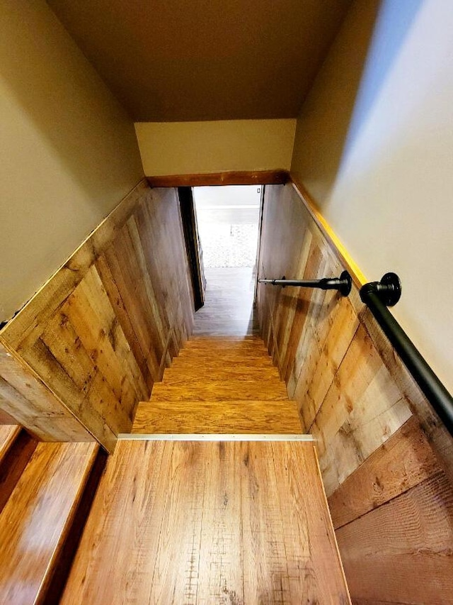 stairway featuring wood finished floors