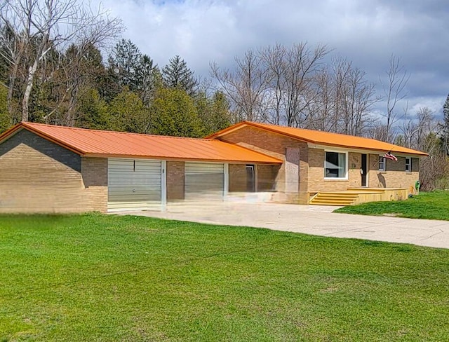 view of front of house with metal roof, brick siding, and a front yard