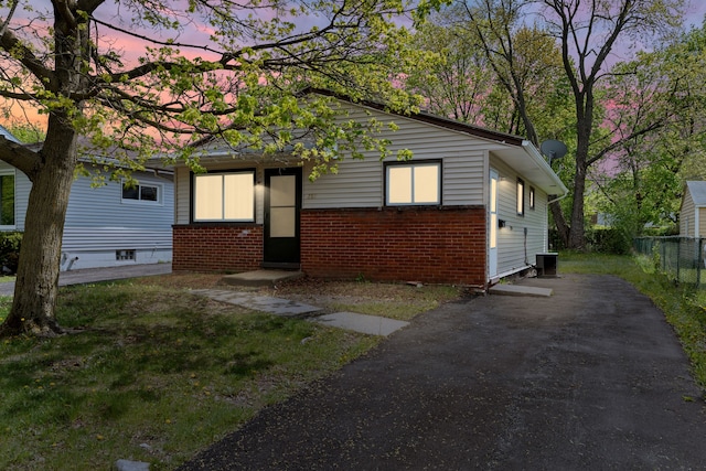 289 Nebraska Ave, Pontiac, MI 48341 - view of front of home featuring fence, central AC unit, driveway, and brick siding