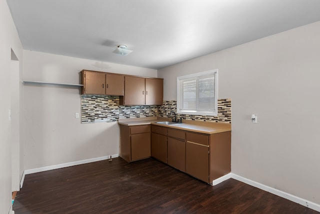 289 Nebraska Ave, Pontiac, MI 48341 - kitchen featuring baseboards, dark wood-style floors, light countertops, a sink, and backsplash