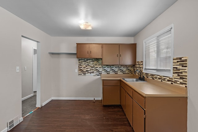 289 Nebraska Ave, Pontiac, MI 48341 - kitchen featuring backsplash, visible vents, dark wood finished floors, light countertops, and a sink