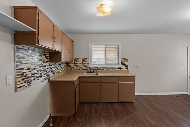289 Nebraska Ave, Pontiac, MI 48341 - kitchen featuring backsplash, light countertops, a sink, and dark wood-type flooring