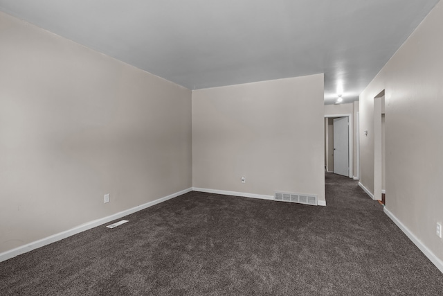 289 Nebraska Ave, Pontiac, MI 48341 - spare room featuring baseboards, dark colored carpet, and visible vents