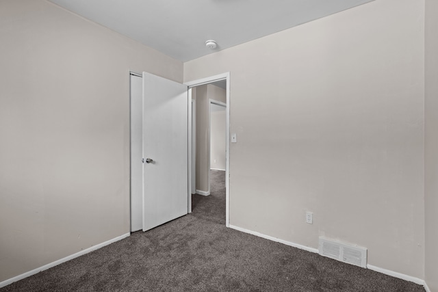 289 Nebraska Ave, Pontiac, MI 48341 - unfurnished bedroom with visible vents, baseboards, and dark colored carpet