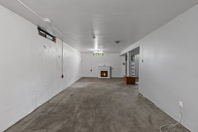 289 Nebraska Ave, Pontiac, MI 48341 - unfurnished living room with a lit fireplace and carpet flooring