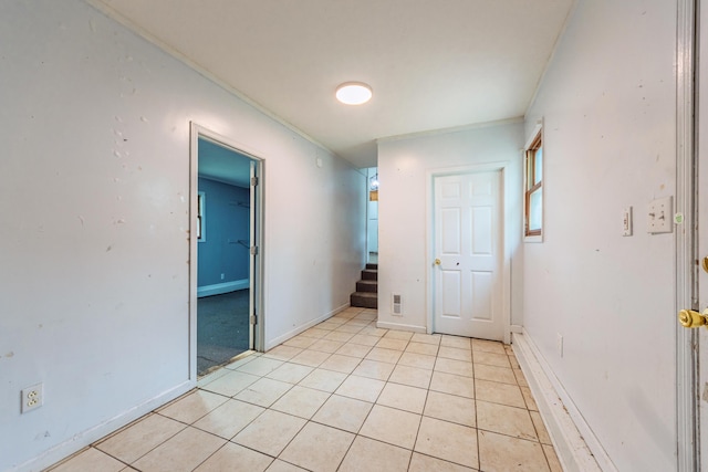 unfurnished bedroom with baseboards, light tile patterned floors, and visible vents