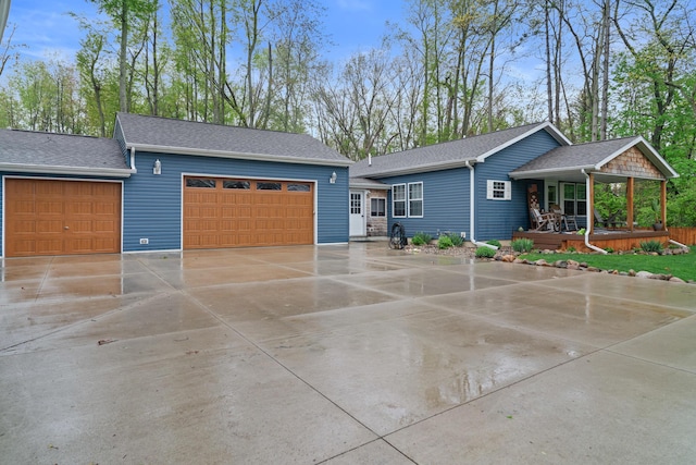 2469 Ash Te Wette Beach Dr, Hillsdale, MI 49242 - view of front facade with a porch, a garage, and a shingled roof