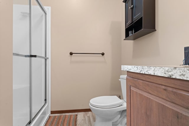 2469 Ash Te Wette Beach Dr, Hillsdale, MI 49242 - full bathroom featuring an enclosed shower, baseboards, vanity, and toilet