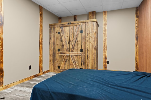 2469 Ash Te Wette Beach Dr, Hillsdale, MI 49242 - bedroom with baseboards, a drop ceiling, and wood finished floors