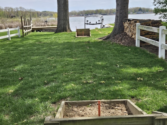 2469 Ash Te Wette Beach Dr, Hillsdale, MI 49242 - view of yard with fence, boat lift, a vegetable garden, a boat dock, and a water view