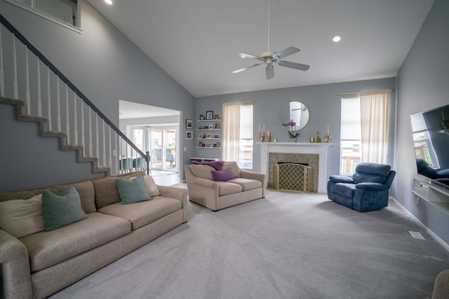 6175 Foxfire Cir, Clarkston, MI 48346 - carpeted living room featuring a ceiling fan, stairs, high vaulted ceiling, a tiled fireplace, and recessed lighting
