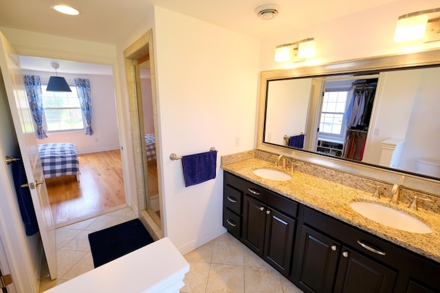bathroom featuring tile patterned floors, a wealth of natural light, and a sink