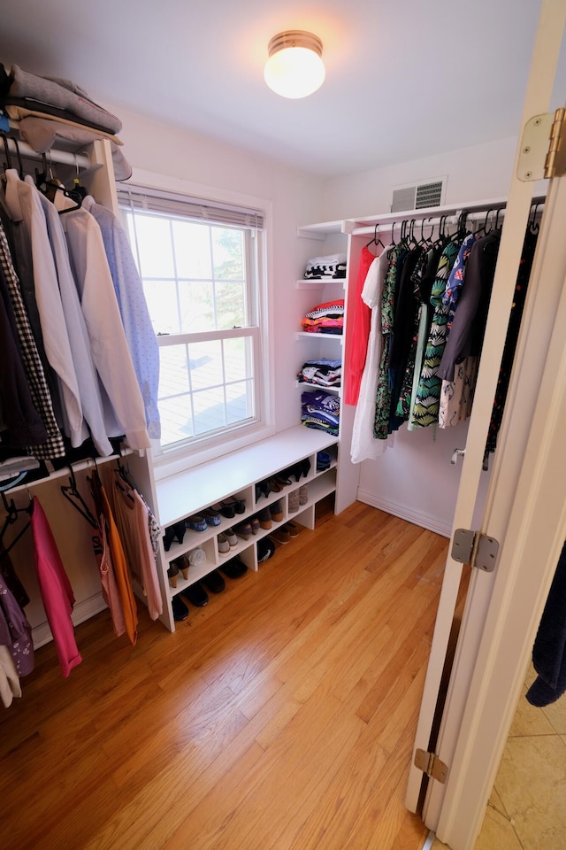 spacious closet featuring visible vents and light wood finished floors