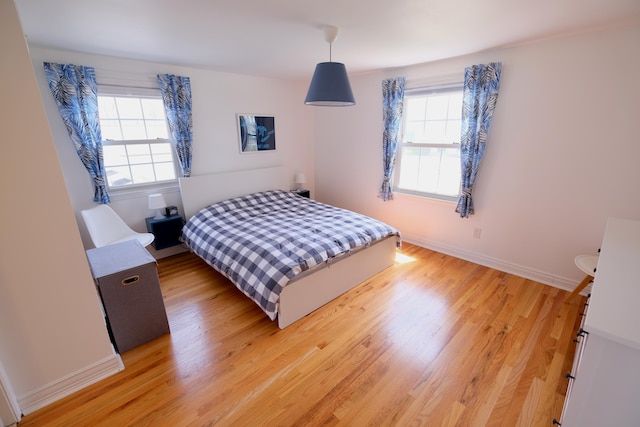 bedroom with baseboards and light wood-style flooring