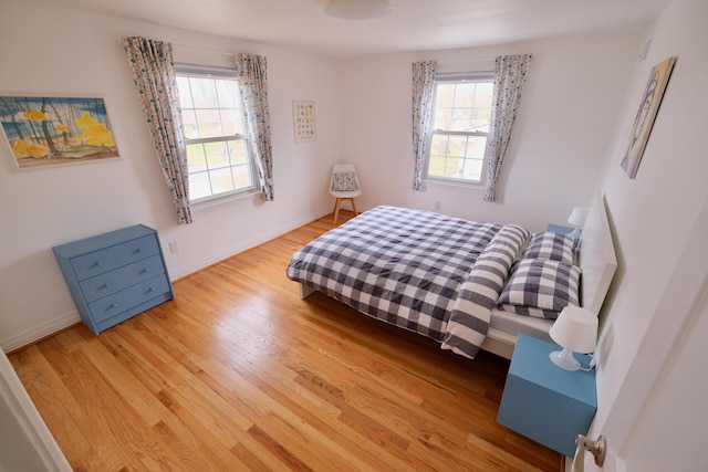 bedroom featuring baseboards and wood finished floors