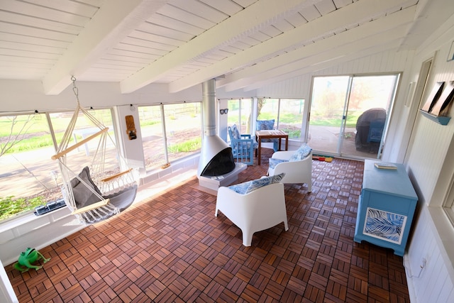 sunroom featuring vaulted ceiling with beams